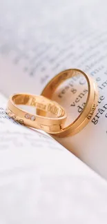 Gold rings resting elegantly on an open book.