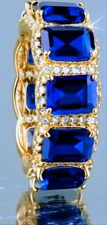 Gold ring with blue sapphires and diamonds in elegant design.
