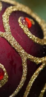 Red Christmas ornament with gold swirls close-up wallpaper.