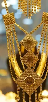 Close-up of an ornate golden necklace with intricate design details.