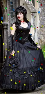 Gothic woman in black dress by stone archway.