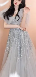 Elegant woman in silver sequin gown with soft peach background.