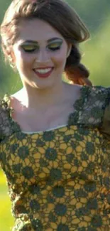 Woman in green lace dress smiling outdoors.