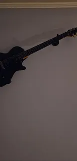 Elegant guitar mounted on a gray wall.
