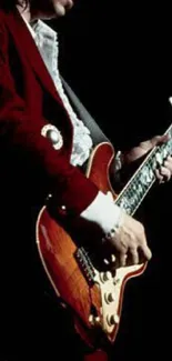 Guitarist passionately playing on a dimly lit stage.