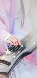 Elegant wallpaper of a hand playing guqin with pink background.