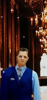 Elegant hallway with chandelier and stylish figure in blue attire.