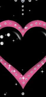 Pink heart with rhinestones on black background.