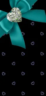 Teal bow with diamond heart on black background.