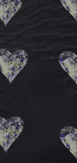 Heart-shaped gemstones on black wallpaper.