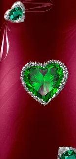 Heart-shaped emerald jewel on maroon background with divine shine.