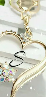 Elegant gold heart-shaped keychain with sparkling details on a white background.