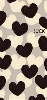 Mobile wallpaper with black and beige heart pattern on gray background.