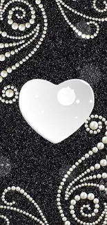 Black wallpaper with a pearl heart design.