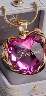 Elegant heart-shaped pendant with pink gemstone set in gold.