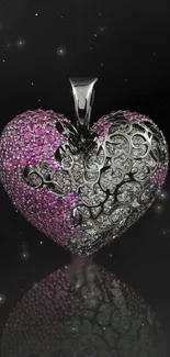 Heart-shaped pendant with pink and silver gemstones on a dark backdrop.