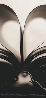 Heart shape formed by book pages creates a romantic mobile wallpaper.