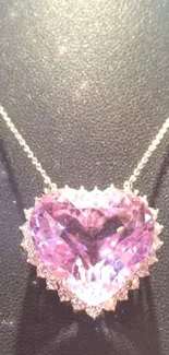 Heart-shaped purple gemstone pendant on black background.