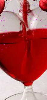 Heart-shaped wine splash with red balloons.