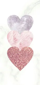 Three textured hearts in a vertical row on a white background.