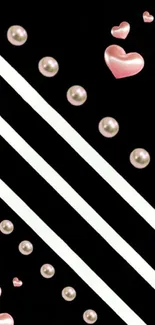 Black wallpaper with pink hearts and pearls on diagonal stripes.