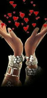 Wallpaper featuring hands with jewelry raising red hearts against a black backdrop.