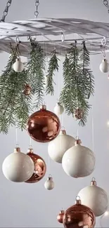 Elegant mobile wallpaper with hanging baubles and pine branches.