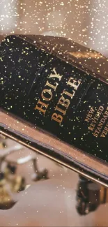 Holy Bible with gold accents and sparkles.