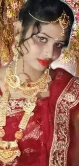 Indian bride with gold jewelry amidst pink floral background.