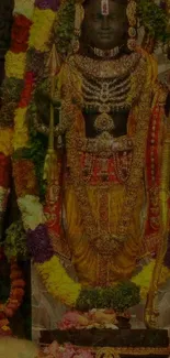 Mobile wallpaper of an Indian deity adorned with colorful garlands and jewelry.