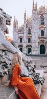 Woman in orange dress admiring iconic Italian cathedral.