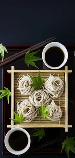 Artistically arranged soba noodles with leaves on a bamboo tray.