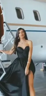 Elegant woman in black dress beside private jet.