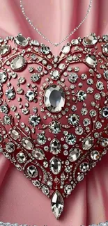 Jewel-encrusted heart on a pink satin background.