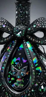 A jeweled black perfume bottle with butterflies and vibrant colors.