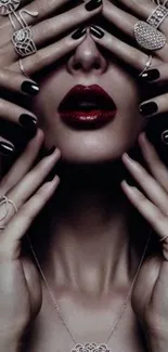 Elegant hands with jewelry and red lips on a black background.