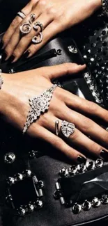 Elegant hands with luxury jewelry and accessories, set on a sleek black background.