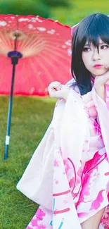 Woman in pink kimono with red umbrella on grass.