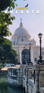 Kolkata architecture framed by trees and an elegant bridge.