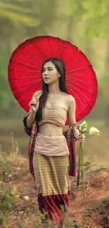 Woman with red umbrella in nature setting.