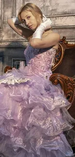 Woman in elegant lavender ball gown sitting on vintage chair.