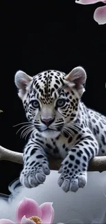 Leopard cub resting on branch with flowers