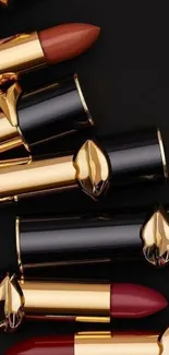 Elegant lipstick arrangement with black and gold.