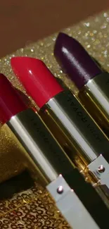 Luxurious lipsticks with a glittering gold background.