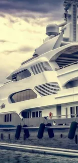 Luxury yacht on water under moody sky wallpaper.