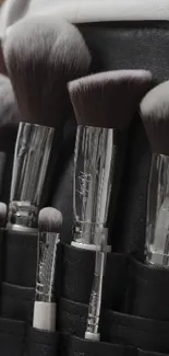 Elegant gray makeup brushes in a stylish holder.