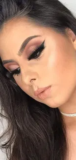 Close-up of woman with elegant makeup and sleek styling.