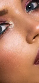 Close-up of woman with elegant makeup and glittery eyeshadow.