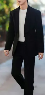 Man in a stylish black suit walking outdoors.