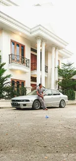 Elegant white mansion with a silver car parked outside, embodying luxury.